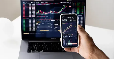 ai investing computer showing stocks - article