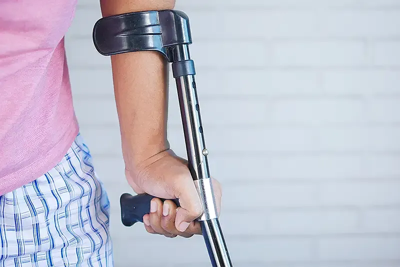 someone walking on crutches.webp